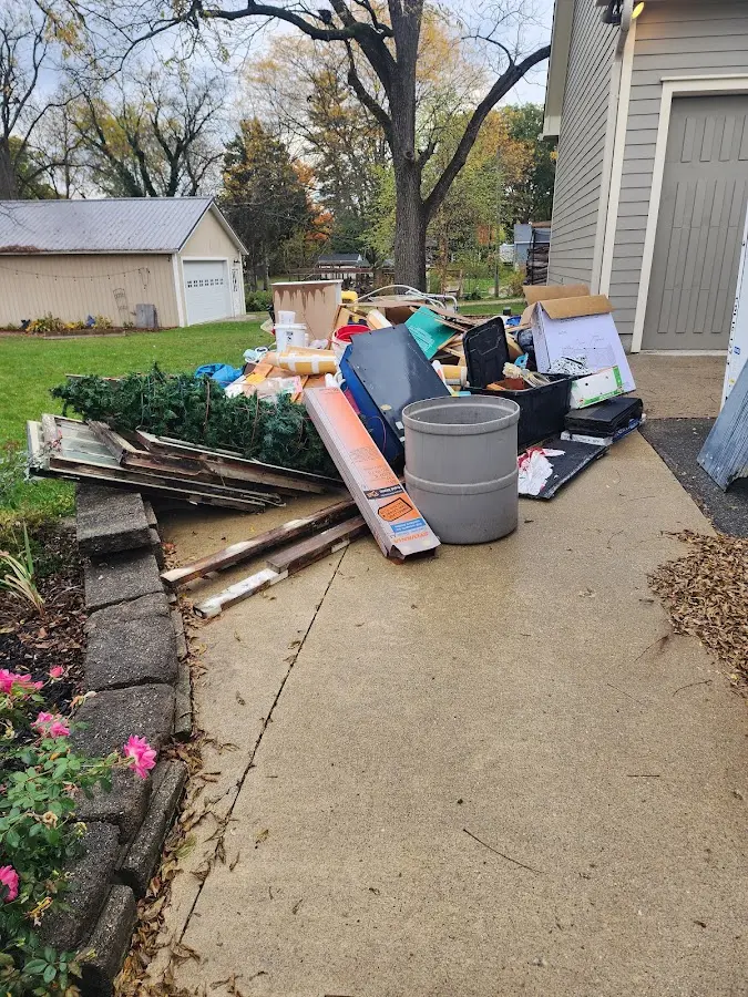 Dumpster being loaded with debris for Demolition Dumpster Rental in McDonald